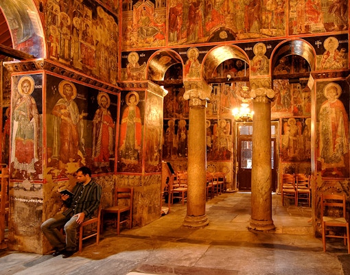 Monastery of Varlaam interior with frescoes and ornate chandeliers, Greece.