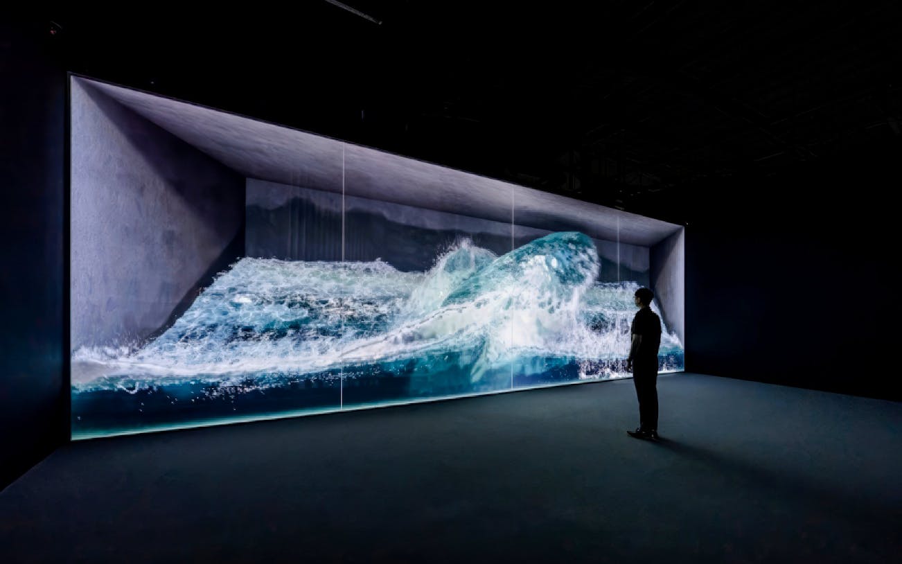 Interactive wave display at Arte Museum Busan with a person observing.