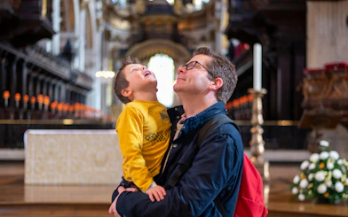 Father and son admiring the interior of St Paul's Cathedral, London.