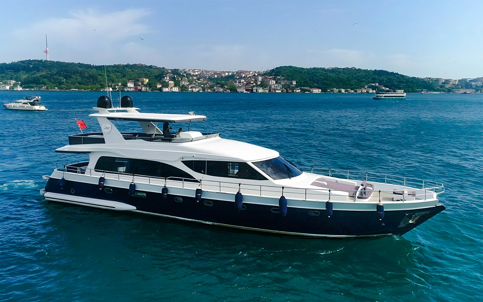Aerial view of a yacht cruising on the Bosphorus Strait in Istanbul, Turkey.
