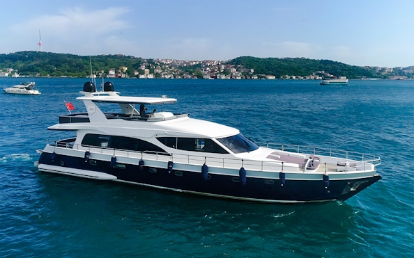 Bosphorus yacht cruising with Istanbul skyline in the background.