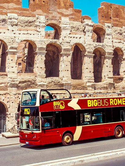 Big Bus Rome tour passing by the Colosseum in Rome, Italy.