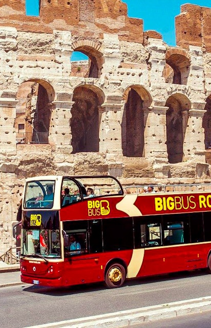 Big Bus Rome tour passing by the Colosseum in Rome, Italy.