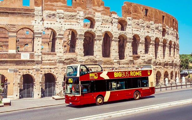 Big Bus Rome tour passing by the Colosseum in Rome, Italy.