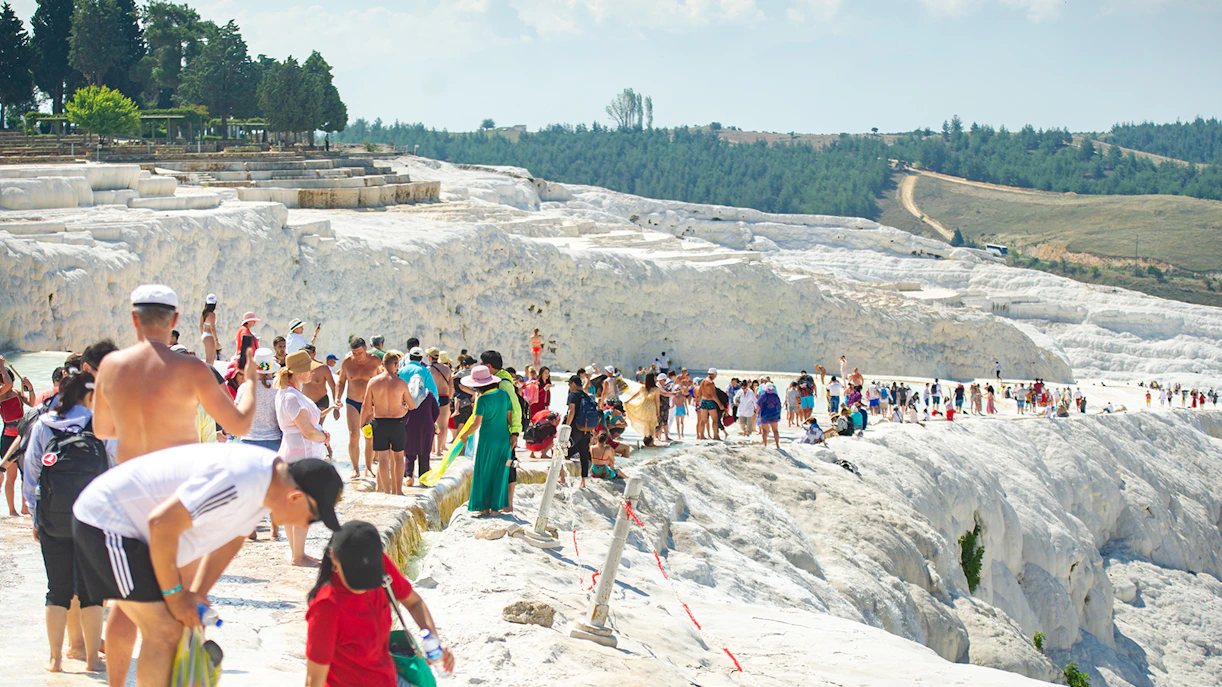 Tourists exploring the travertine terraces of Pamukkale, Turkey.