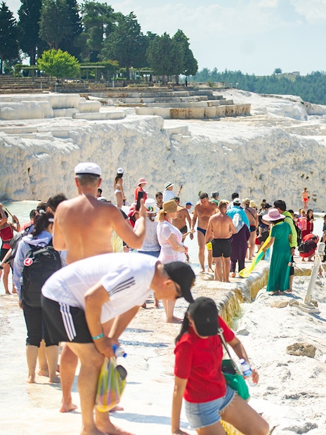 Tourists exploring the travertine terraces of Pamukkale, Turkey.
