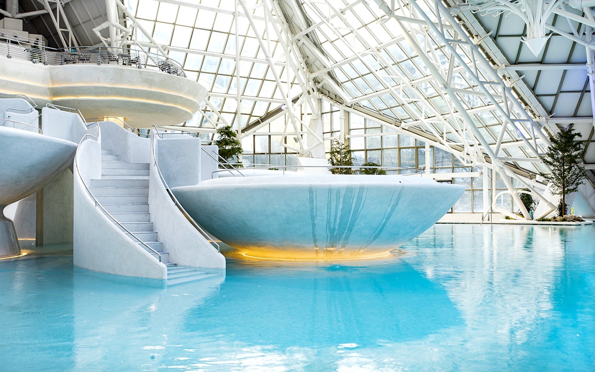 Indoor thermal pool at Caldea spa center in Andorra with modern architecture.