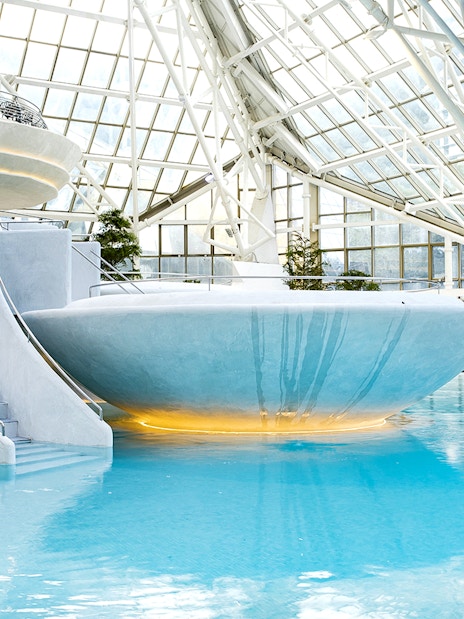Indoor thermal pool at Caldea spa center in Andorra with modern architecture.