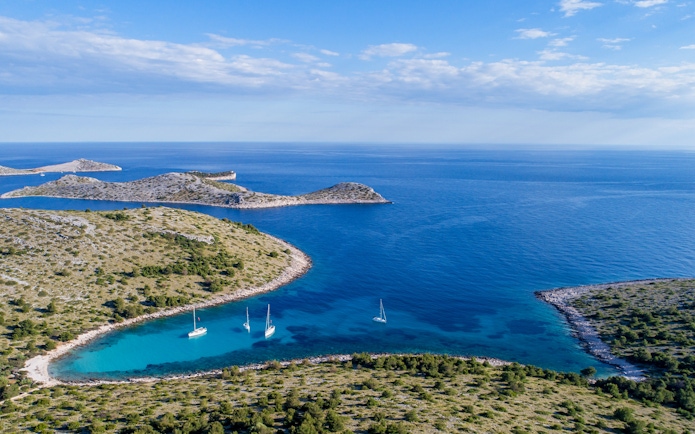 Panoramic aerial view of Kornati Islands National Park, Dalmatia, Croatia, with sailboats in turquoise waters.
