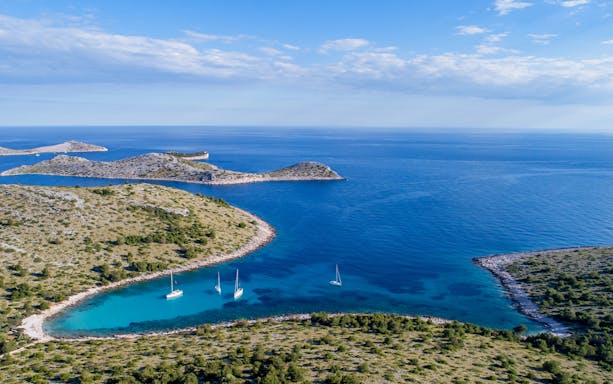 Panoramic aerial view of Kornati Islands National Park, Dalmatia, Croatia, with sailboats in turquoise waters.