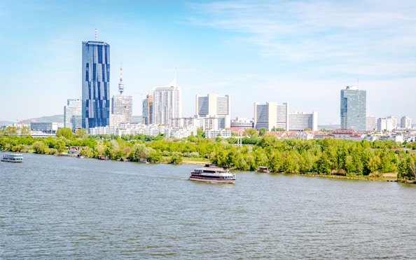 Vienna skyline with Danube River in foreground, Austria.