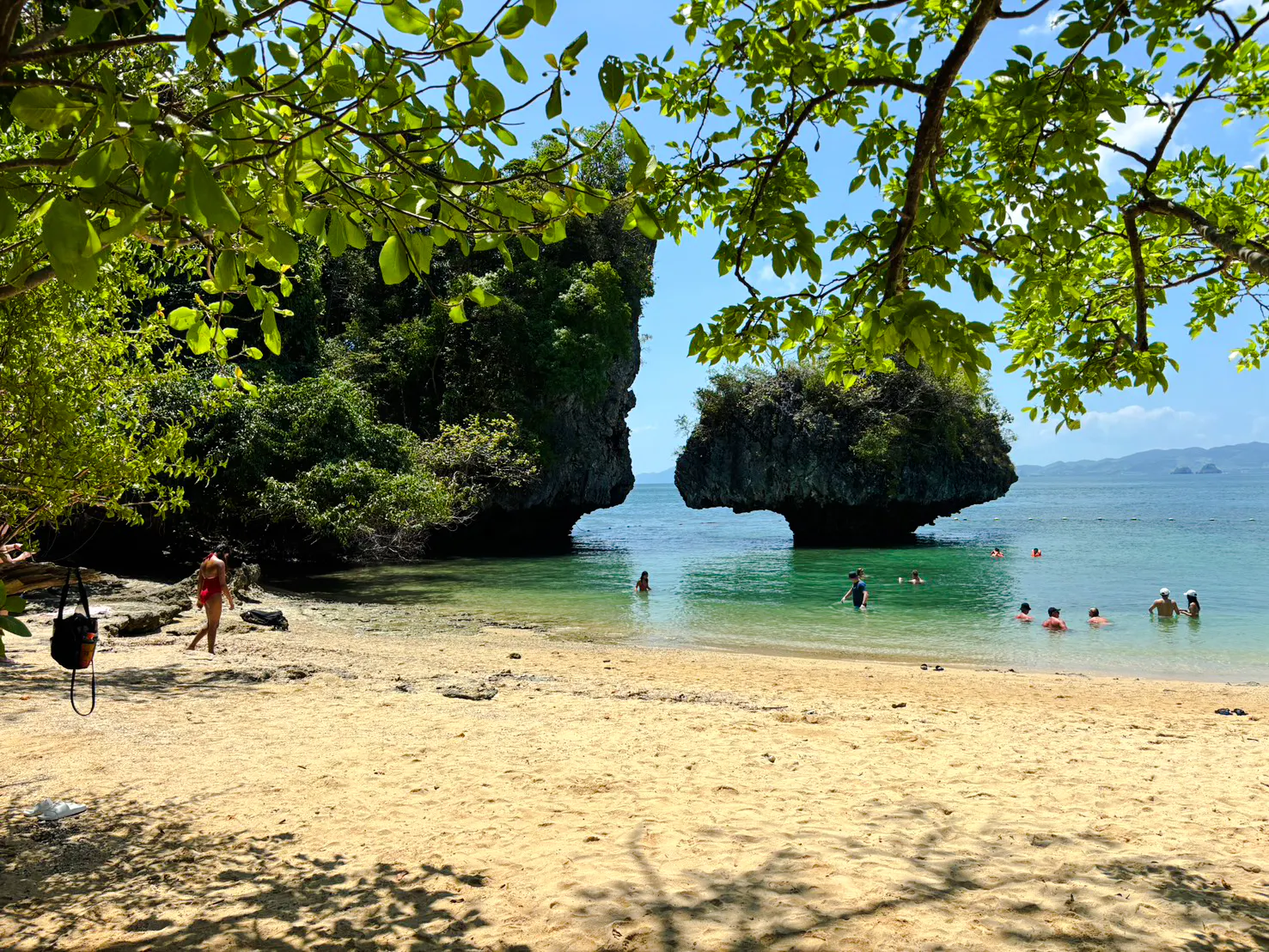 Visitors swimming near limestone formations at Hong Islands beach, Krabi.