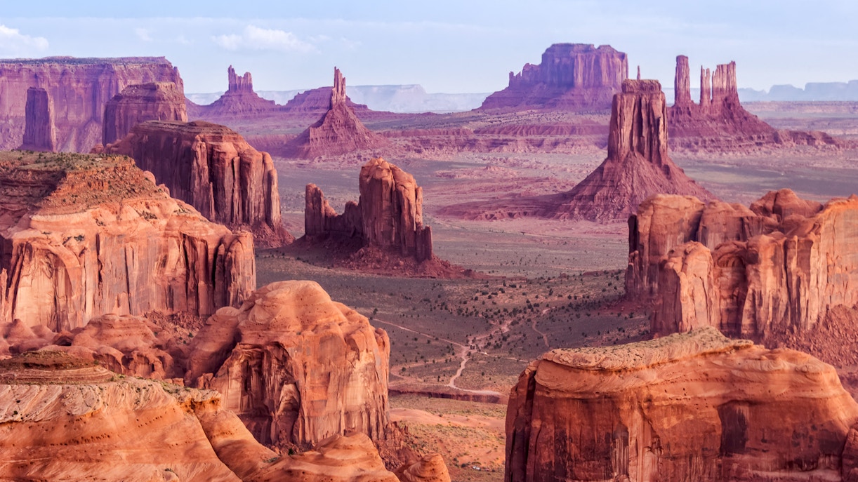 Sunrise over Hunts Mesa with red rock formations near Monument Valley, Arizona, USA.