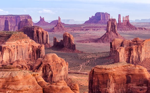 Sunrise over Hunts Mesa with red rock formations near Monument Valley, Arizona, USA.