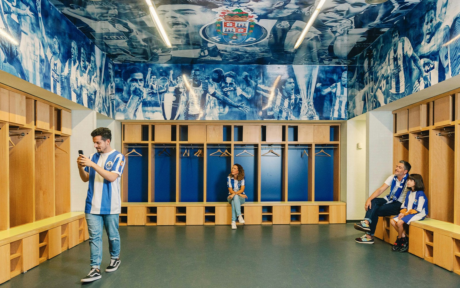 Visitors exploring FC Porto stadium museum dressing room.