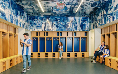 Visitors exploring FC Porto stadium museum dressing room.