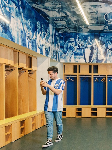 Visitors exploring FC Porto stadium museum dressing room.