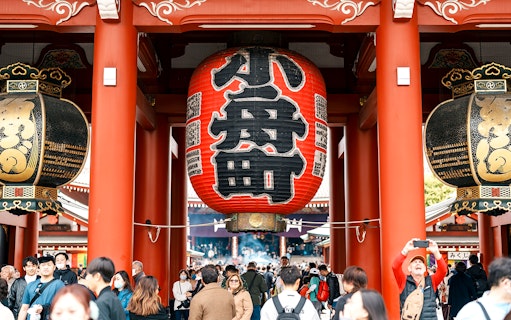 Crowd at Senso-ji Temple entrance with large red lantern, Asakusa, Tokyo.