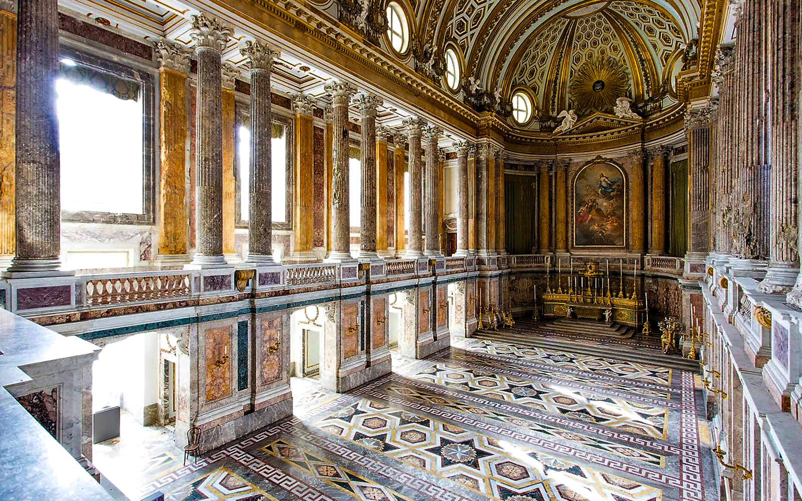 Palatine Chapel interior with ornate columns and detailed ceiling at Royal Palace of Caserta.
