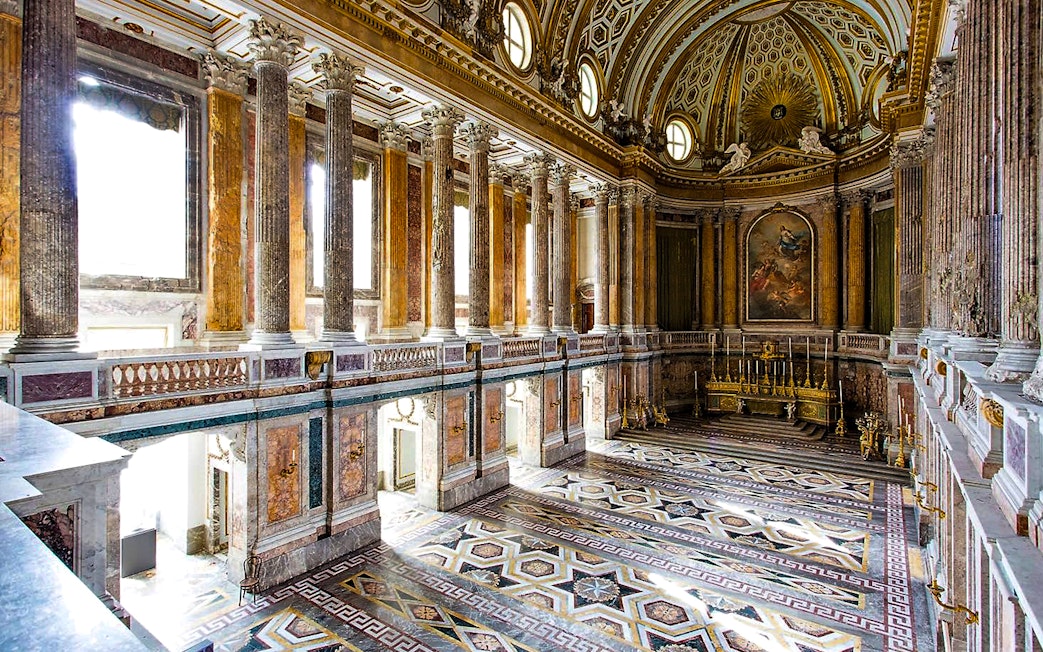 Palatine Chapel interior with ornate columns and detailed ceiling at Royal Palace of Caserta.