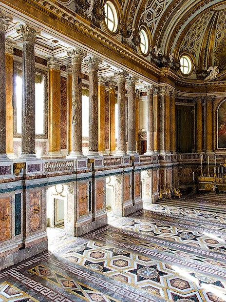 Palatine Chapel interior with ornate columns and detailed ceiling at Royal Palace of Caserta.