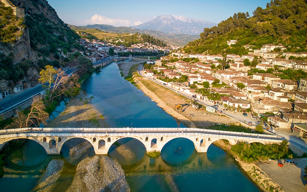 Berati cityscape with stone bridge over Osumi River, Albania.