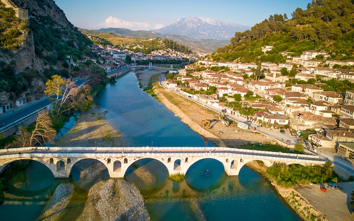 Berati cityscape with stone bridge over Osumi River, Albania.