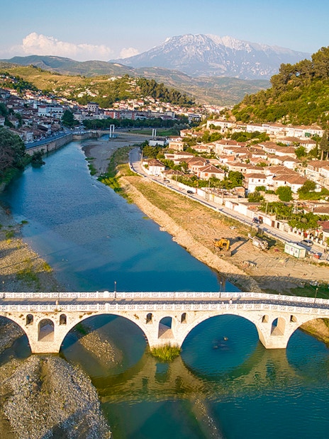 Berati cityscape with stone bridge over Osumi River, Albania.