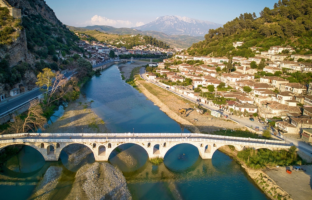 Berati cityscape with stone bridge over Osumi River, Albania.