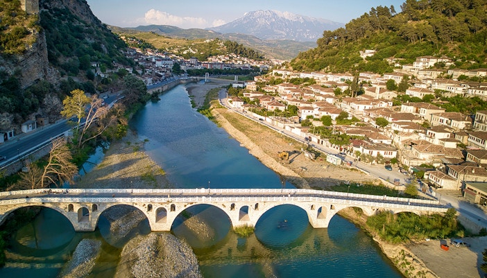 Berati cityscape with stone bridge over Osumi River, Albania.