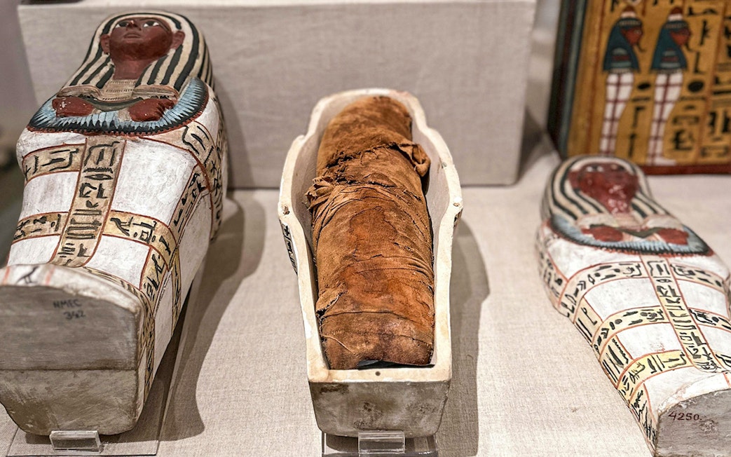 Mummy and sarcophagi at the National Museum of Egyptian Civilization in Cairo.