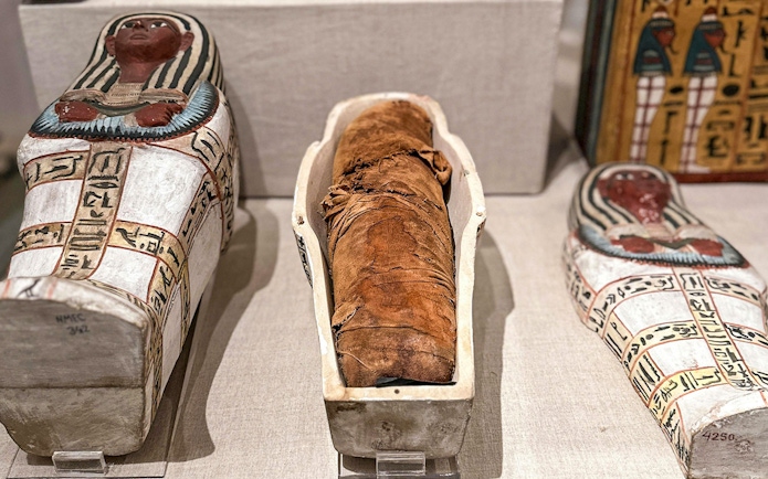 Mummy and sarcophagi at the National Museum of Egyptian Civilization in Cairo.