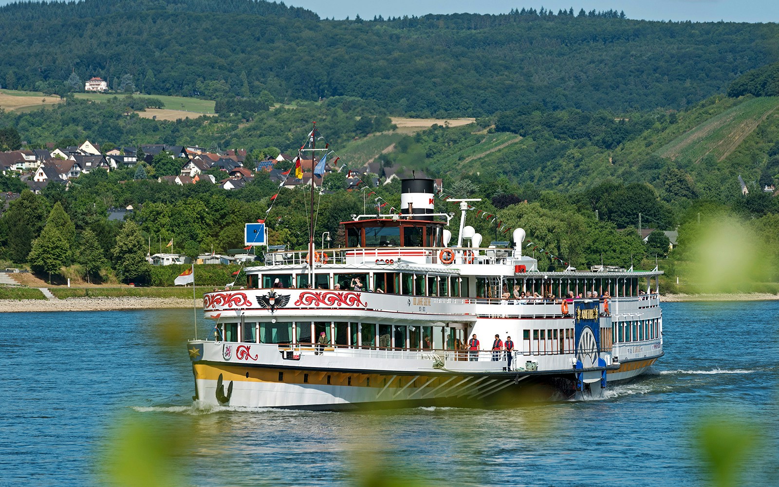 Ein Ausflugsschiff fährt auf einem Fluss entlang