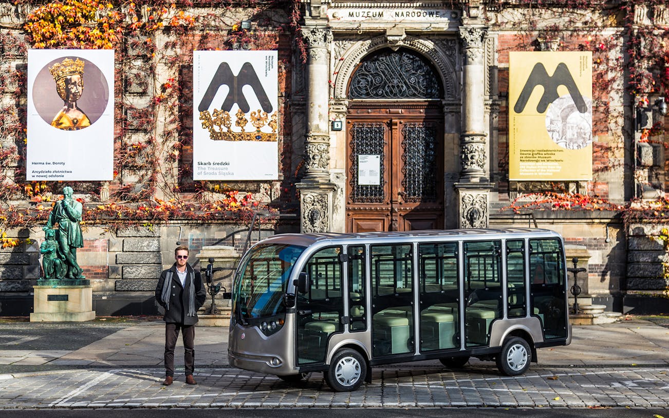 Electric car parked outside the National Museum in Wroclaw during a group tour.