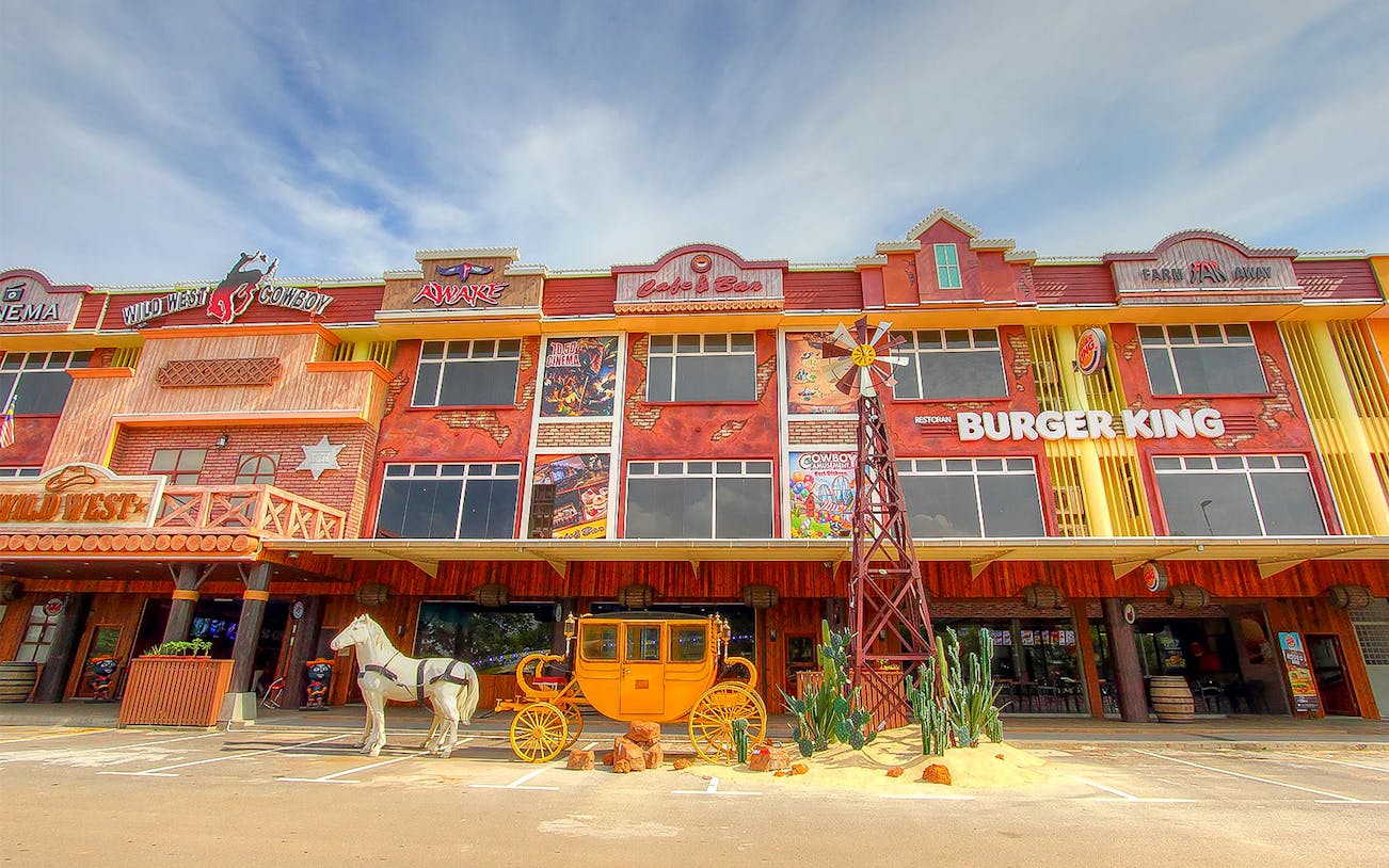 Wild West Cowboy theme park entrance with stagecoach and windmill.