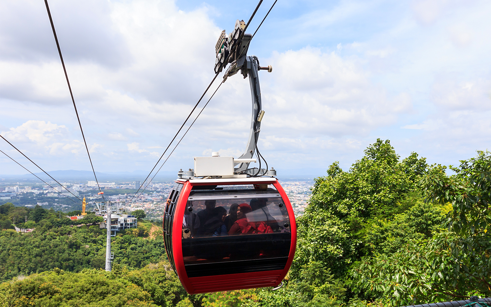 Montserrat cable car ascending mountain in Catalonia, Spain, with scenic views of rugged peaks.