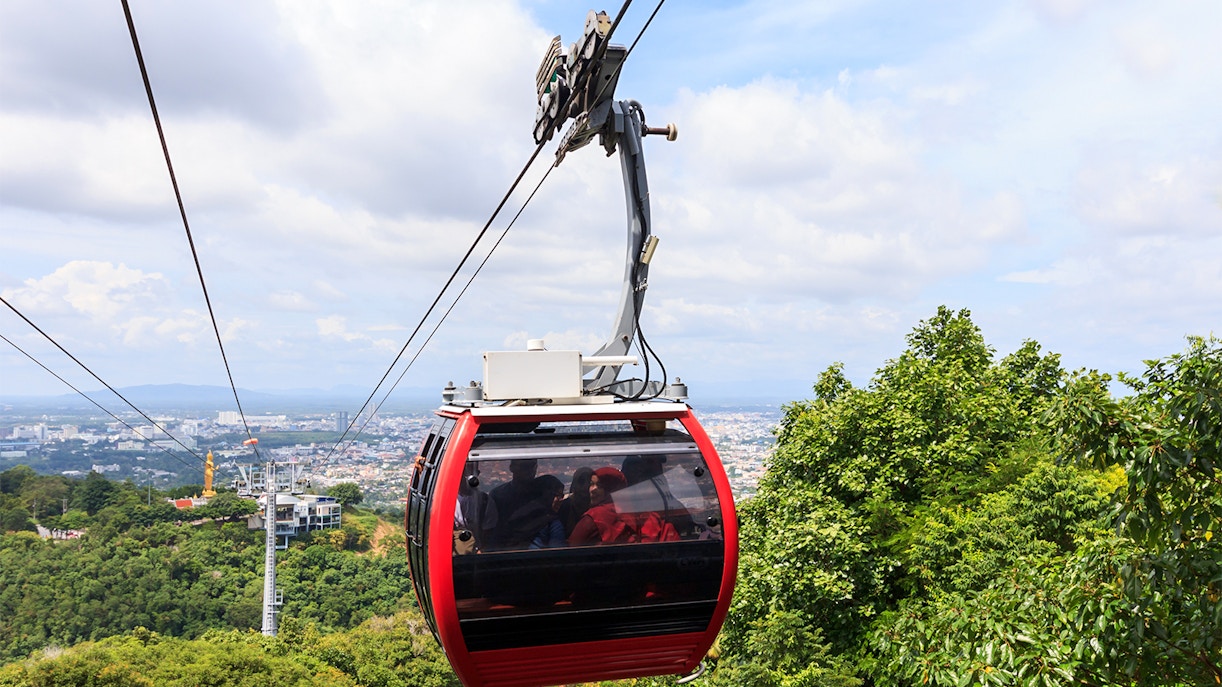 Montserrat cable car ascending mountain in Catalonia, Spain, with scenic views of rugged peaks.