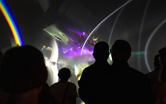Visitors viewing Olafur Eliasson's light installation at Gallery of Modern Art.