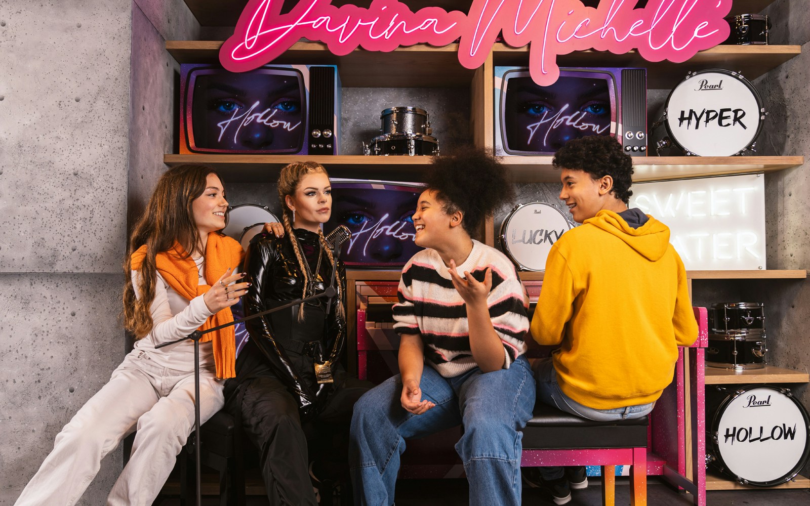 Visitors interacting with Davina Michelle wax figure at Madame Tussauds Amsterdam.