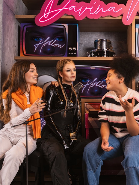 Visitors interacting with Davina Michelle wax figure at Madame Tussauds Amsterdam.