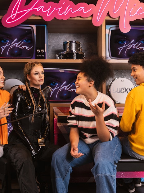 Visitors interacting with Davina Michelle wax figure at Madame Tussauds Amsterdam.