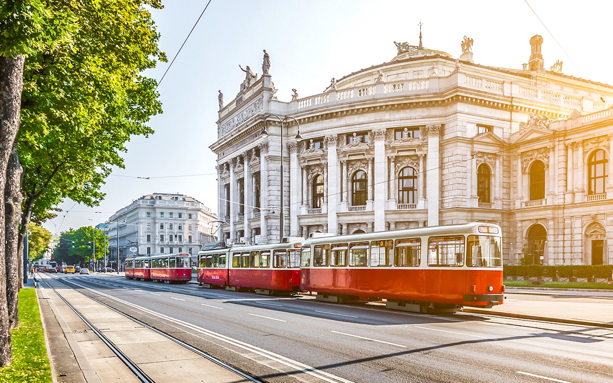 Red tram passing by the Burgtheater in Vienna, Austria.