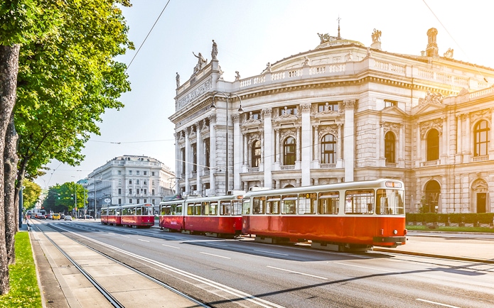 Red tram passing by the Burgtheater in Vienna, Austria.