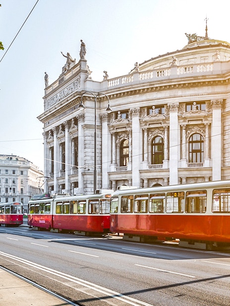 Red tram passing by the Burgtheater in Vienna, Austria.
