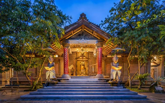 Arma Museum Resort entrance with statues and evening lighting in Bali.