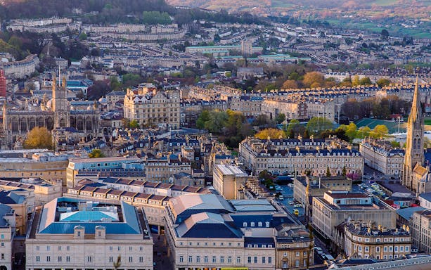 Aerial view of Bath, featuring Bath Abbey and surrounding Georgian architecture.