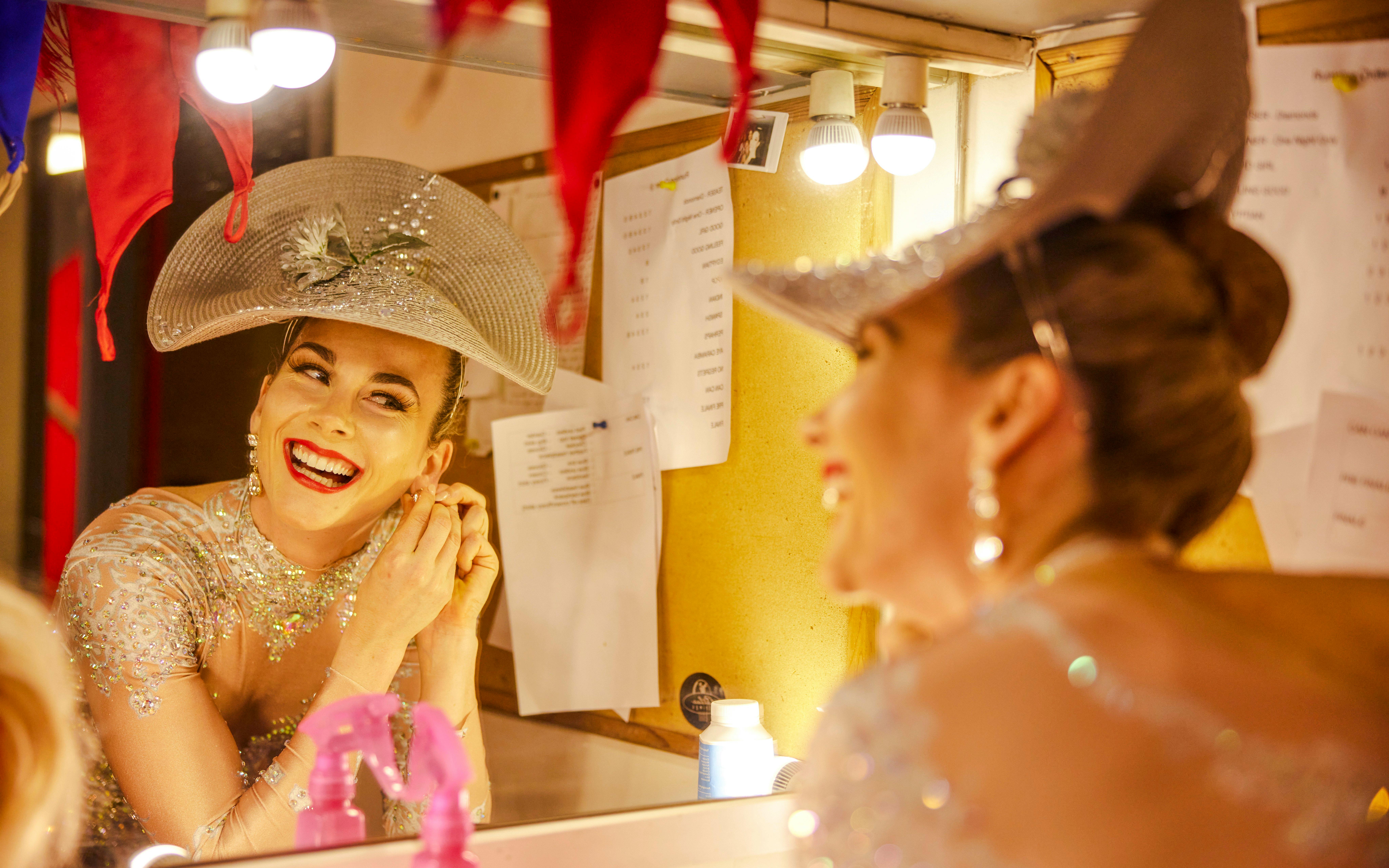 Performer preparing backstage for Showboat Vivid Sydney dinner cruise cabaret.