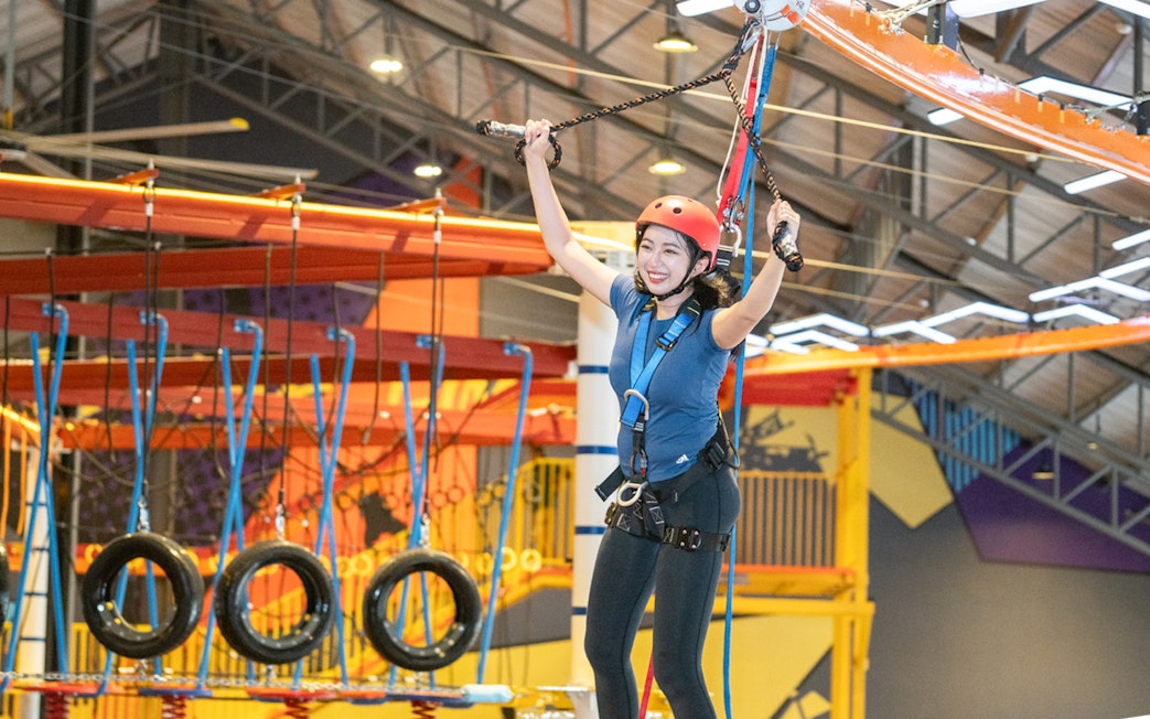 Person enjoying a ropes course at Monkey Canopy Resort's Indoor Extreme Park.