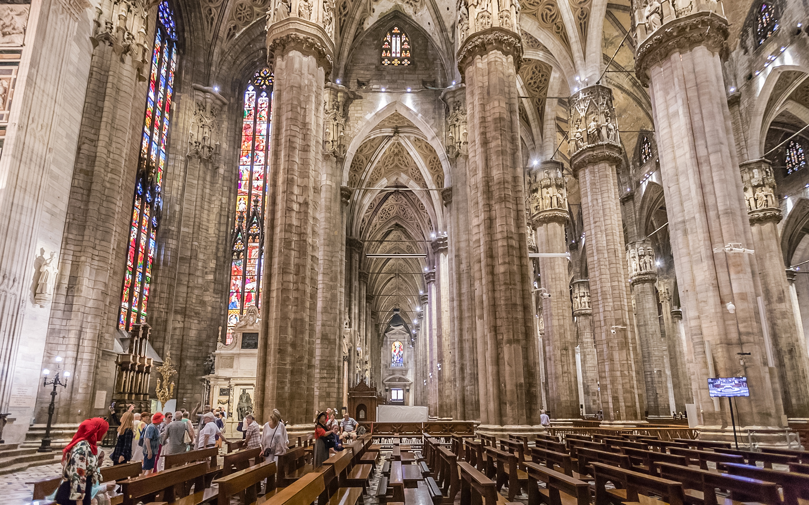 Duomo Cathedral interior in Milan with ornate columns and detailed ceiling.