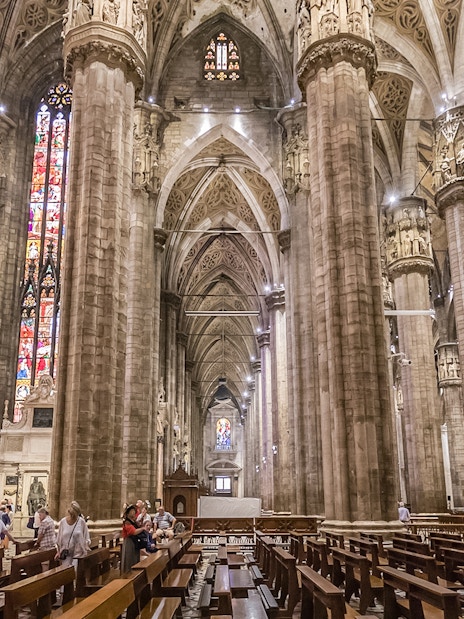 Duomo Cathedral interior in Milan with ornate columns and detailed ceiling.